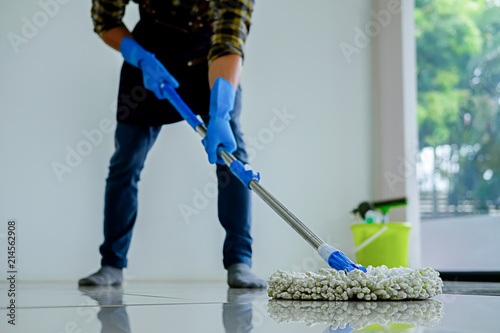 Cleaning Service concept. Cleaners employee removing dirt with equipment in office.