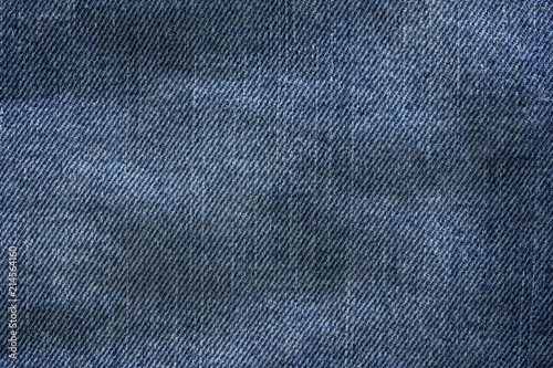Old blue denim jeans texture or background with visible fibers © knlml
