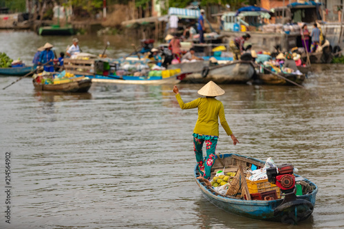 Boat woman in floating market in Mekong River, Vietnam