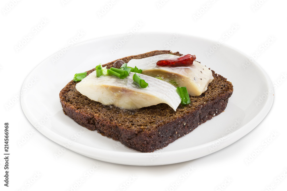 Open sandwich with pickled herring slices on brown bread closeup Open sandwich with pickled herring slices on brown bread closeup
