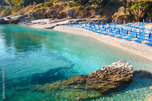 Beach chairs with umbrella. Beautiful sea view. Corfu Island.