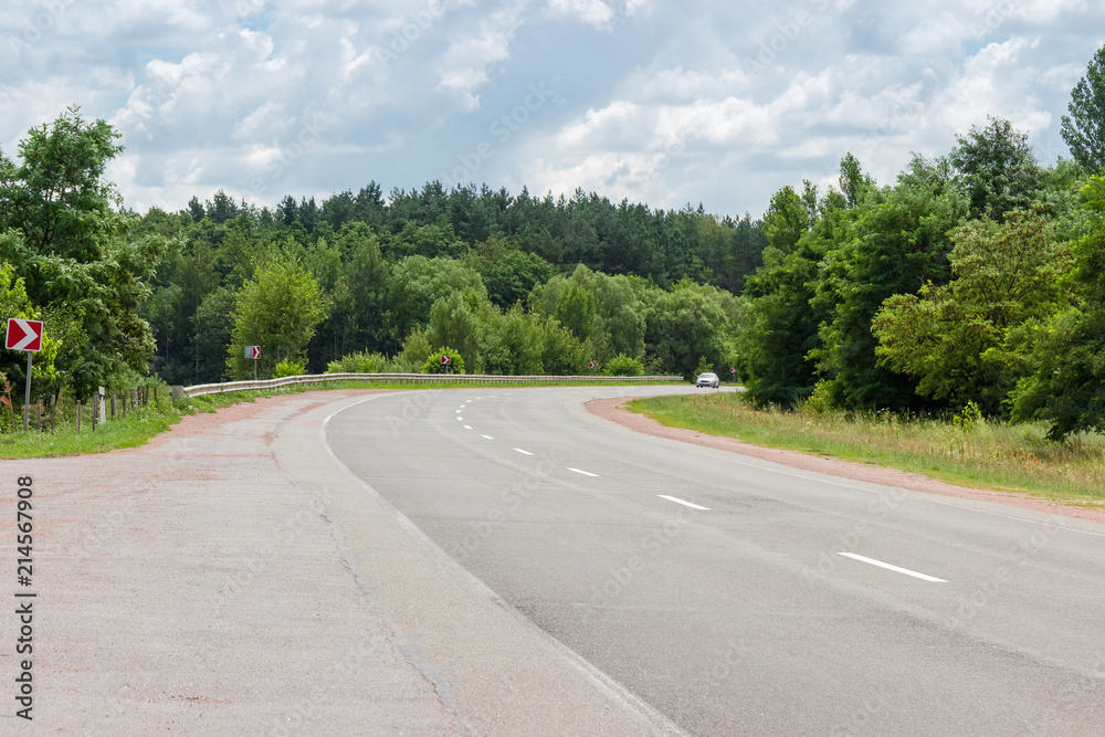 Turn of the roadway with forest on both sides Turn of the roadway with forest on both sides