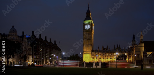 Big Ben, Houses of Parliament, London by night, midnight, with buses and unrecognisable people. photo