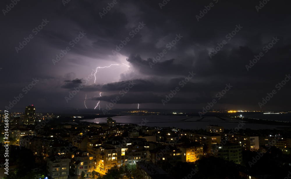 Spectacular Thunderstorm in dark night sky above city