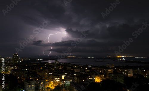 Spectacular Thunderstorm in dark night sky above city