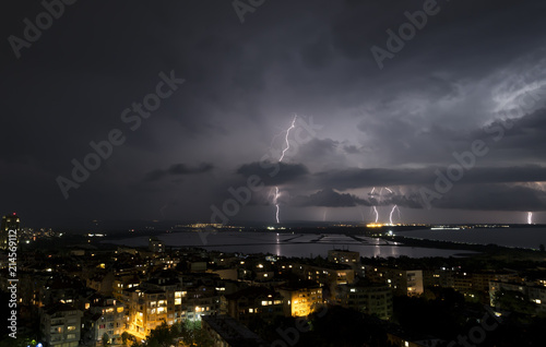 Spectacular Thunderstorm in dark night sky above city