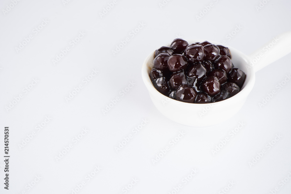 black pearls. Boiled tapioca pearls for bubble tea on white background. Copy space