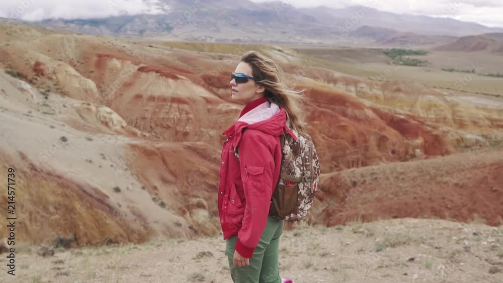 portrait of a traveler in the mountains. red mountains and red earth as on Mars portrait of a traveler in the mountains. red mountains and red earth as on Mars