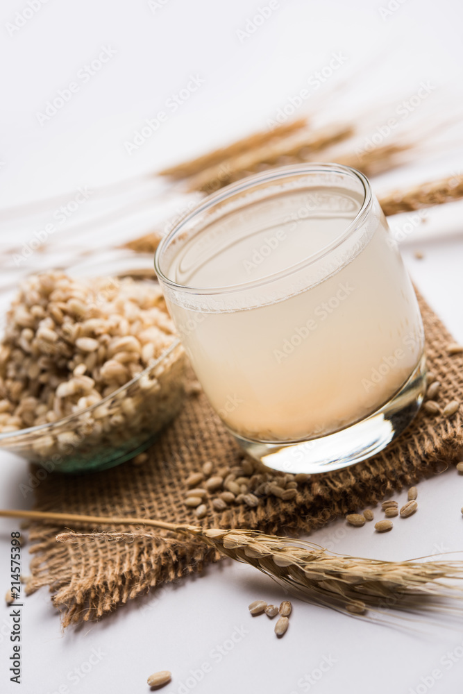 Barley water in glass with raw and cooked pearl barley wheat/seeds. selective focus Barley water in glass with raw and cooked pearl barley wheat/seeds. selective focus