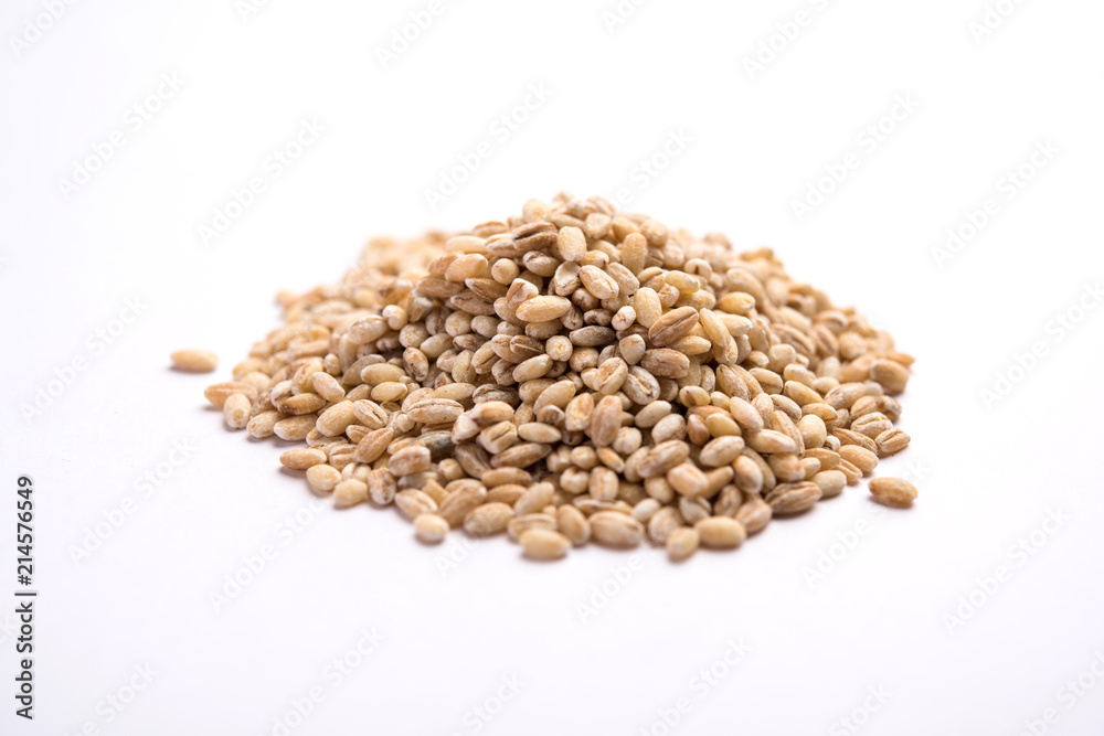 Raw and cooked Barley pearl seeds in a bowl or over white plate. selective focus Raw and cooked Barley pearl seeds in a bowl or over white plate. selective focus
