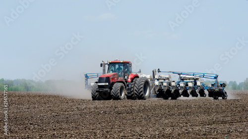 Tractor sowing the corn on the field