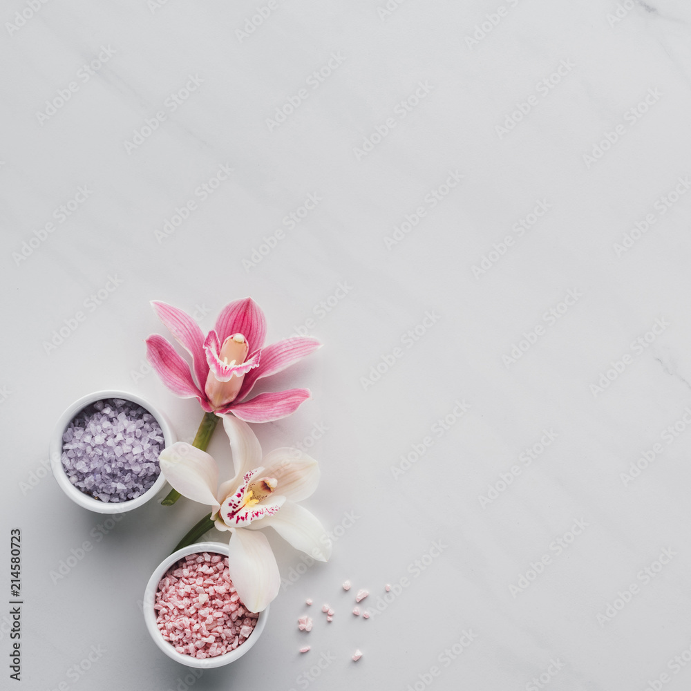 top view of beautiful orchid flowers and sea salt in bowls on white background top view of beautiful orchid flowers and sea salt in bowls on white background