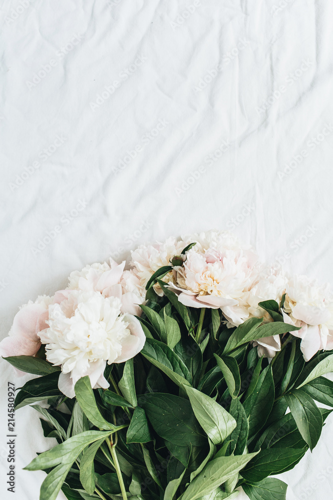Flat lay, top view of white peonies flower bouquet on white blanket background. Flat lay, top view of white peonies flower bouquet on white blanket background.