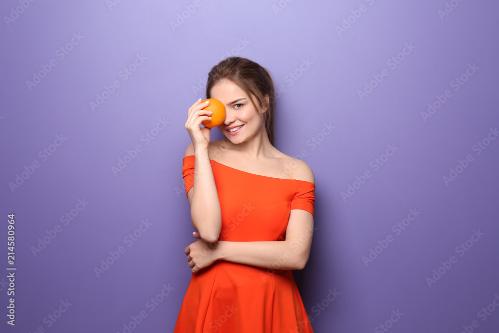 Beautiful young woman with citrus fruit on color background Beautiful young woman with citrus fruit on color background