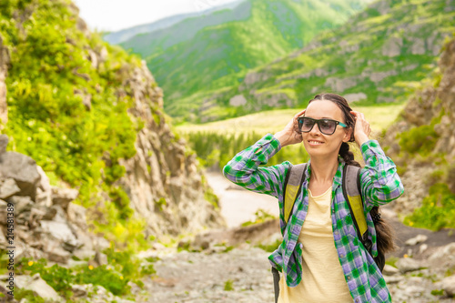 Happy smiling woman hiking in mountains enjoying outdoor activity. Space for text