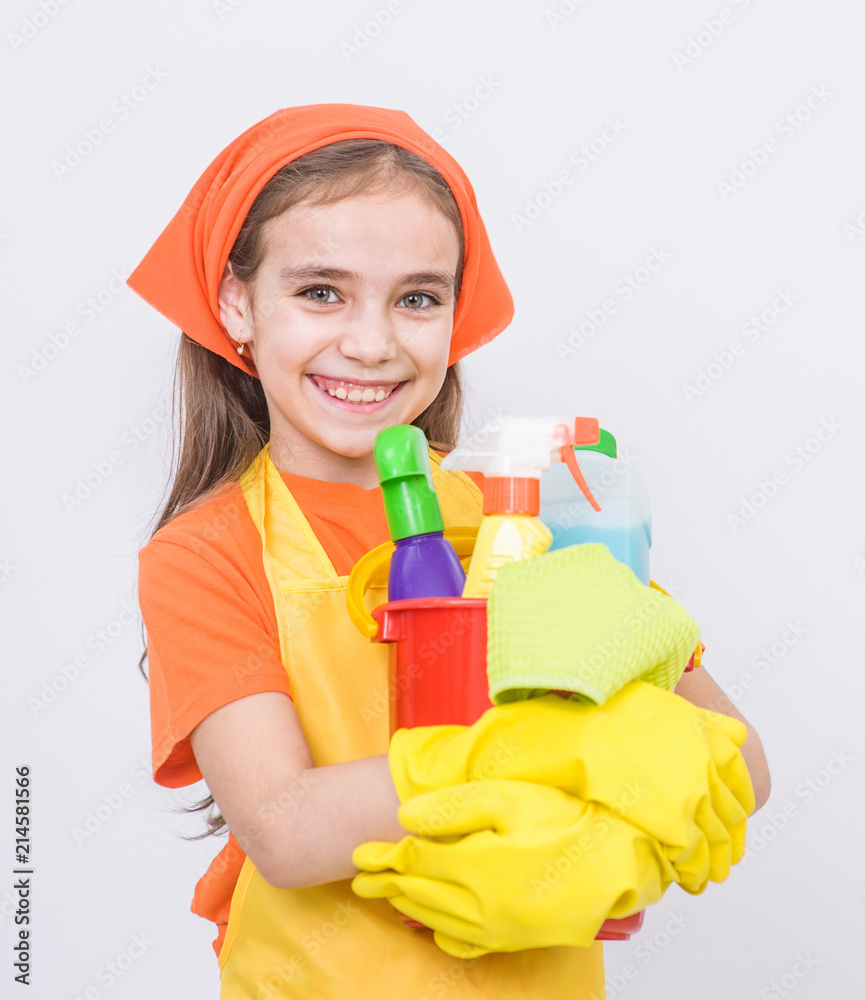 Happy girl with cleaning supplies in bucket standing on white background Happy girl with cleaning supplies in bucket standing on white background
