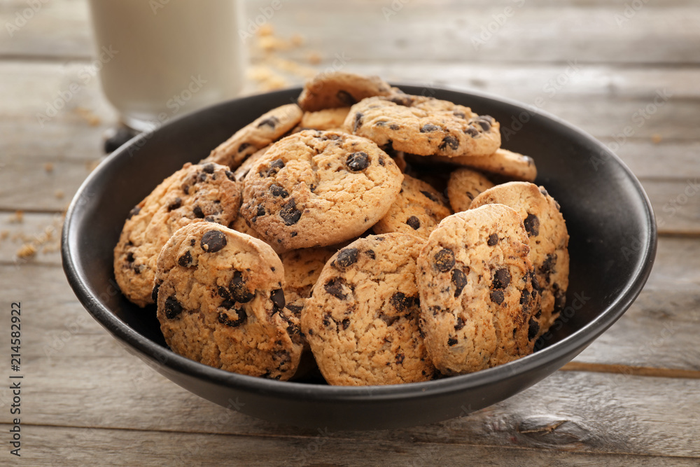 Plate with delicious chocolate chip cookies on wooden table Plate with delicious chocolate chip cookies on wooden table