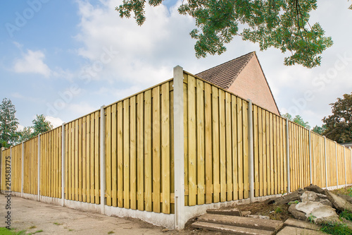 New wooden fence at garden of house