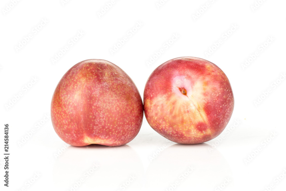Group of two whole fresh pluot interspecific plums variety isolated on white Group of two whole fresh pluot interspecific plums variety isolated on white