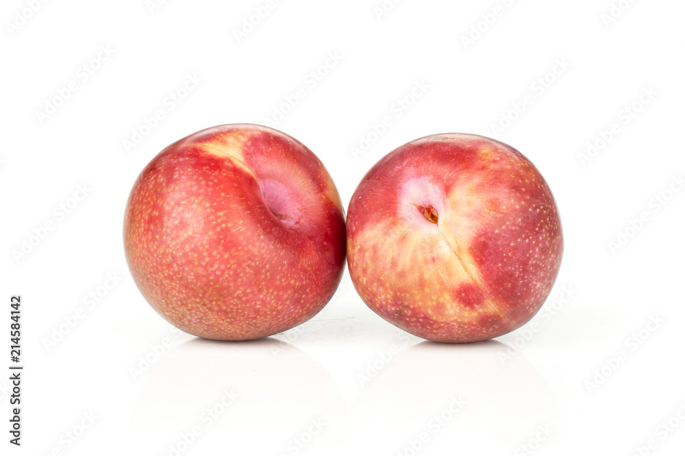 Group of two whole fresh pluot interspecific plums variety isolated on white Group of two whole fresh pluot interspecific plums variety isolated on white