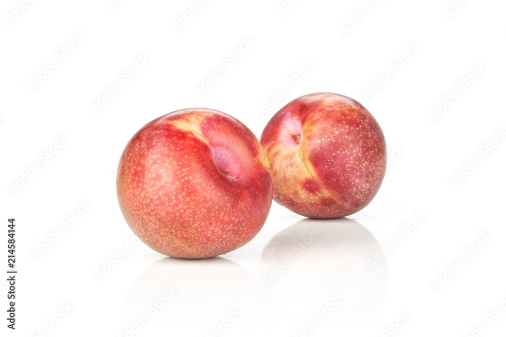 Group of two whole fresh pluot interspecific plums variety isolated on white Group of two whole fresh pluot interspecific plums variety isolated on white