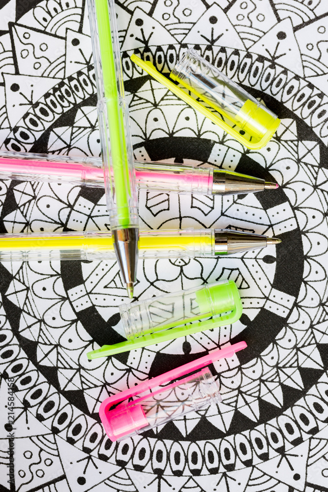 Obraz premium Adult coloring book, new stress relieving trend. Art therapy, mental health, creativity and mindfulness concept. Adult coloring page with pastel colored gel pens, Flat lay background.
