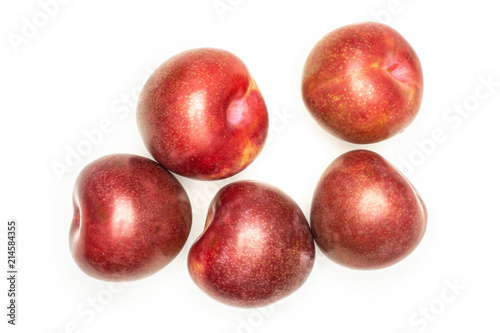 Group of five whole fresh pluot interspecific plums variety flatlay isolated on white