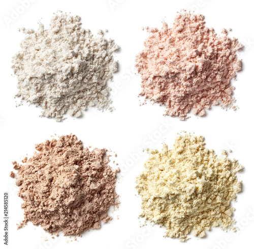 Four various heaps of protein powder (vanilla, strawberry, chocolate, banana) photo