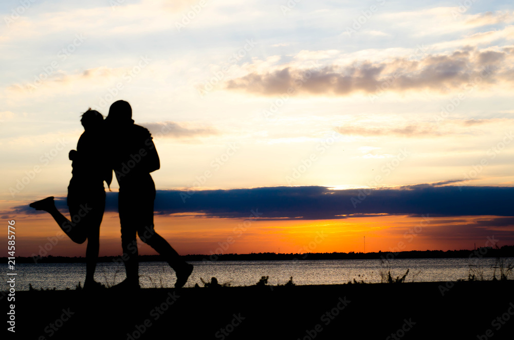 Couple woman silhouette hug because nostalgia during sunset and beautiful sky.