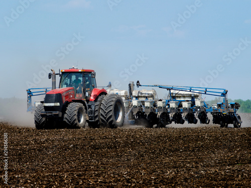 Tractor sowing the corn on the field