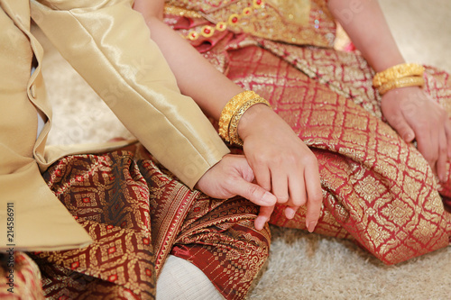 Thai wedding ceremony. Bride and groom hands.
