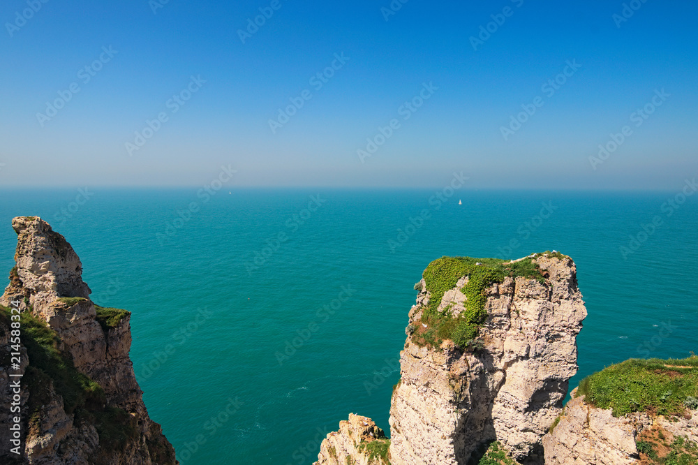 Beautiful landscape on the cliff of Etretat, cliff and beach. Coast of the Pays de Caux area in sunny spring day. Etretat, Seine-Maritime department, Normandy, France