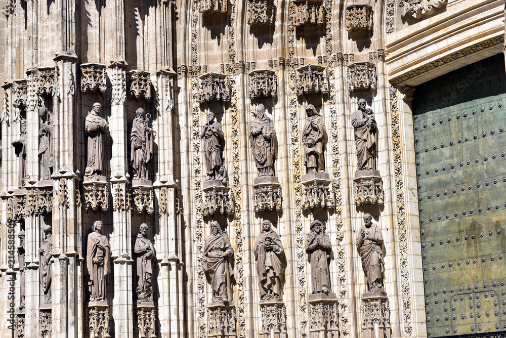 Architecture details over entrance door of Seville Cathedral, Spain