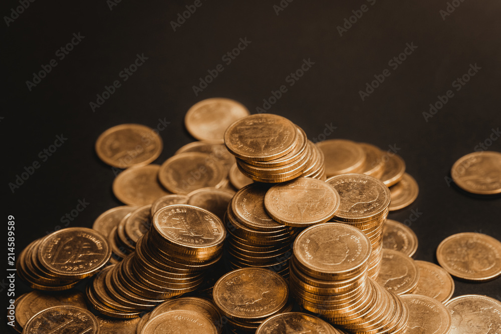 Savings, increasing columns of coins, piles of coins arranged as a graph in dark room, business banking concept. Savings, increasing columns of coins, piles of coins arranged as a graph in dark room, business banking concept.