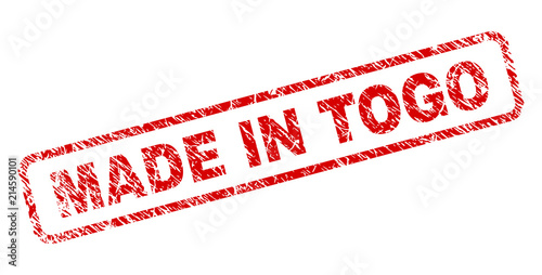 MADE IN TOGO stamp seal print with distress style. Red vector rubber print of MADE IN TOGO text with retro texture. Text label is placed inside rounded rectangle frame.