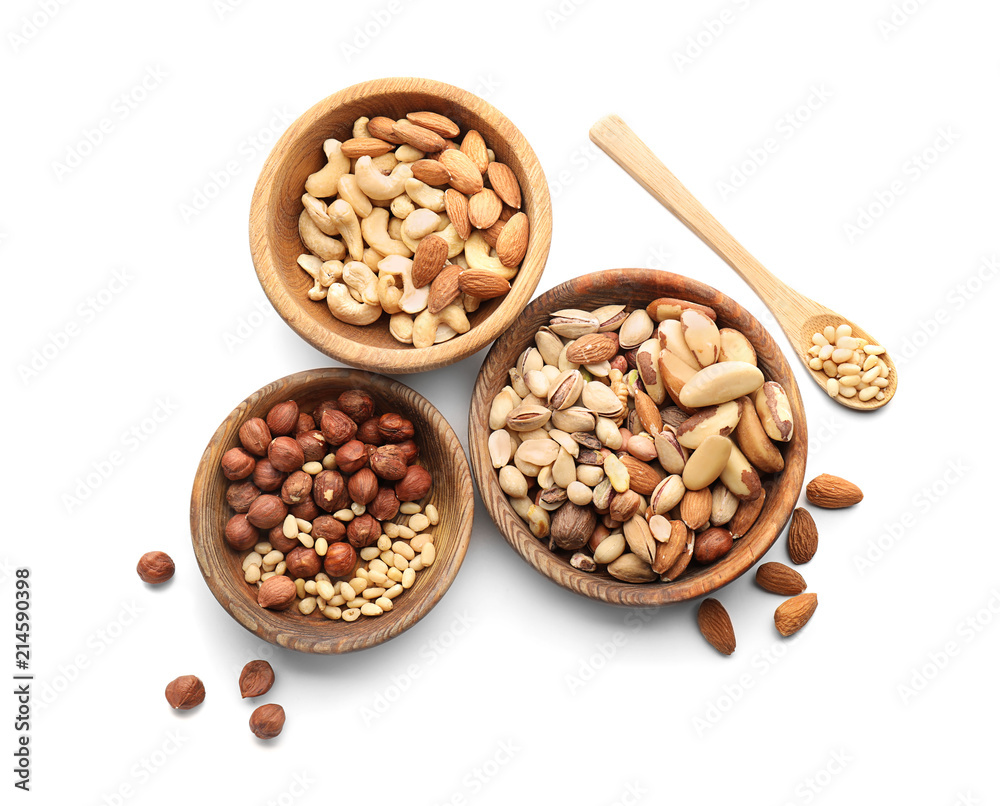 Bowls with different nuts on white background Bowls with different nuts on white background