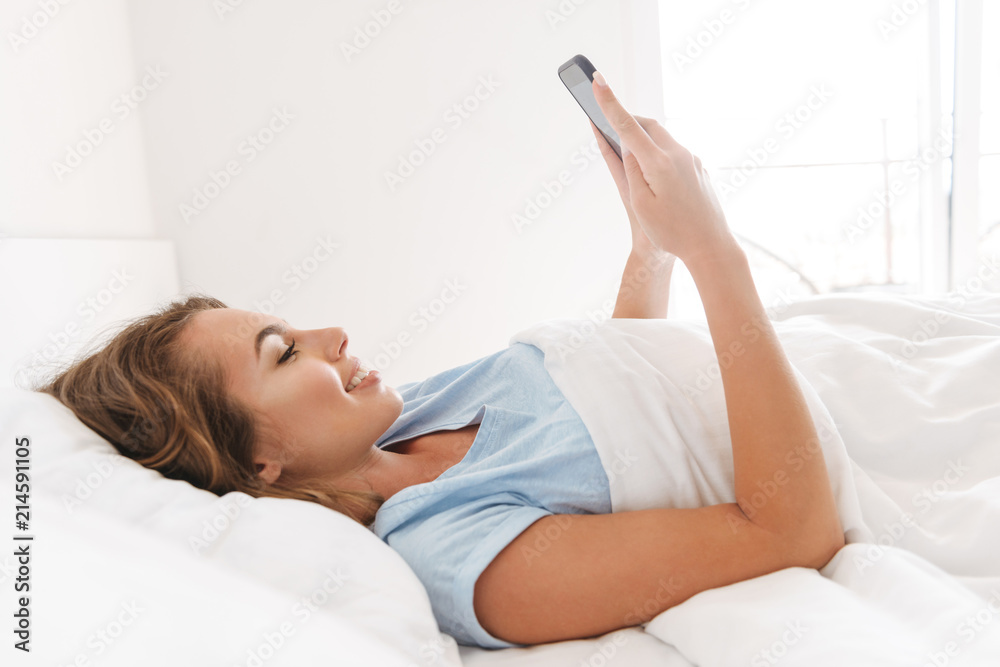 Happy young woman using mobile phone Happy young woman using mobile phone