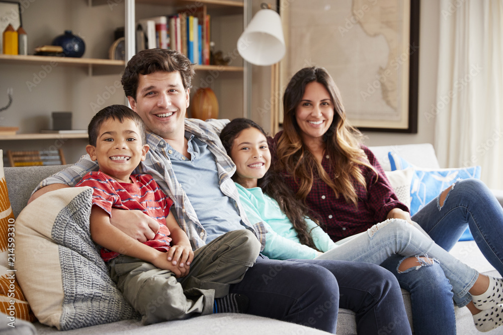Portrait Of Happy Family Relaxing On Sofa At Home Together Portrait Of Happy Family Relaxing On Sofa At Home Together