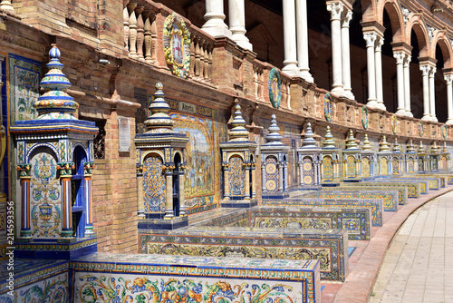 Decorative painted ceramic tiles in alcoves in Plaza de Espana, Seville, Andalusia, Spain © akturer