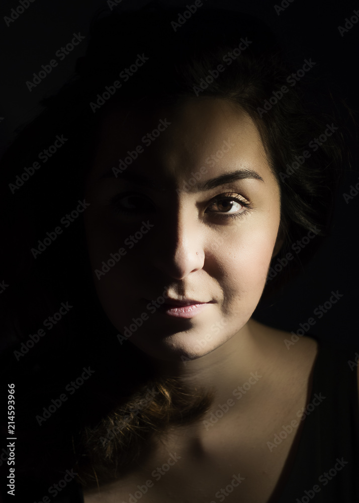 Beautiful woman in the light. Half light, half dark