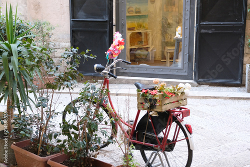 Old bicycle with a box of flowers as a decoration on a city street