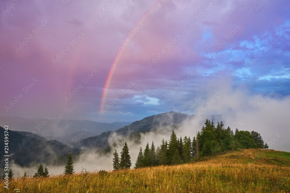 Mountain nature photo background with bright rainbow Mountain nature photo background with bright rainbow
