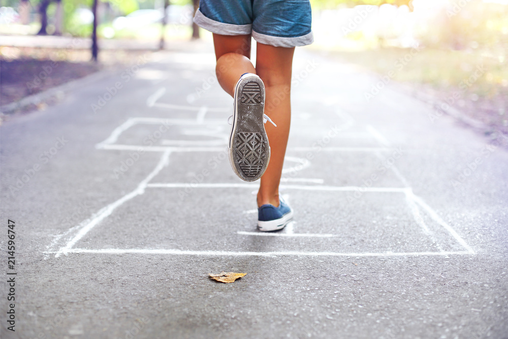 Kid playing hopscotch on playground outdoors foto de Stock | Adobe Stock