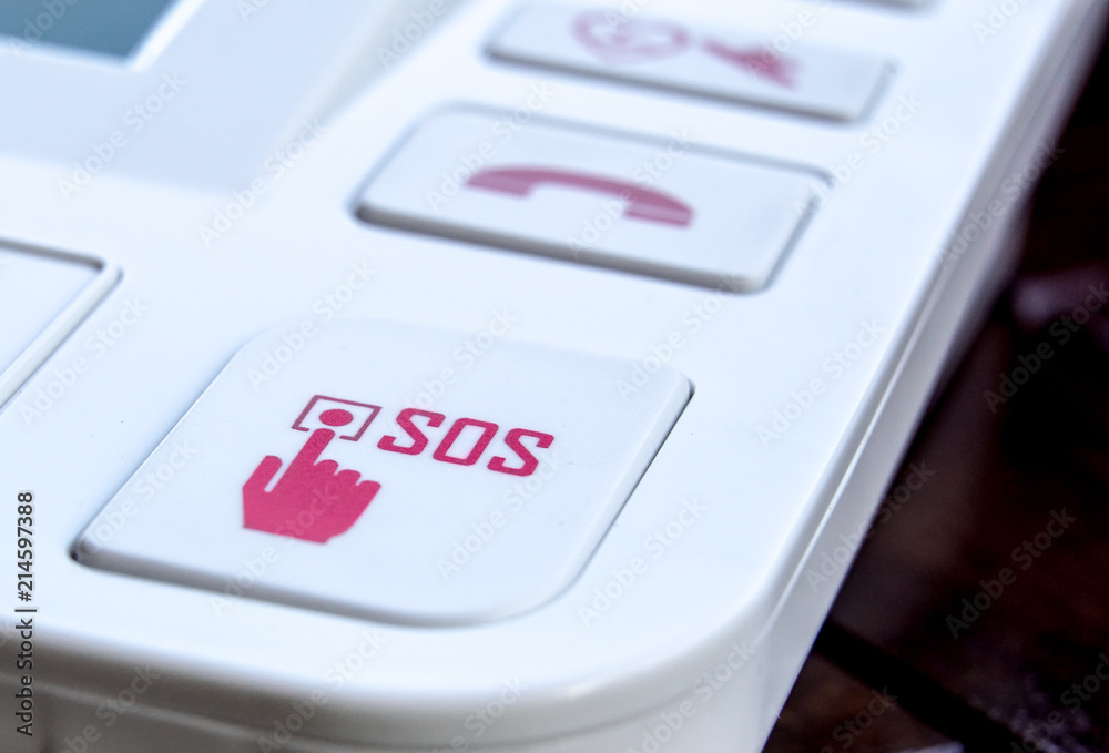 sos Red button on a dirty old panel, selective focus