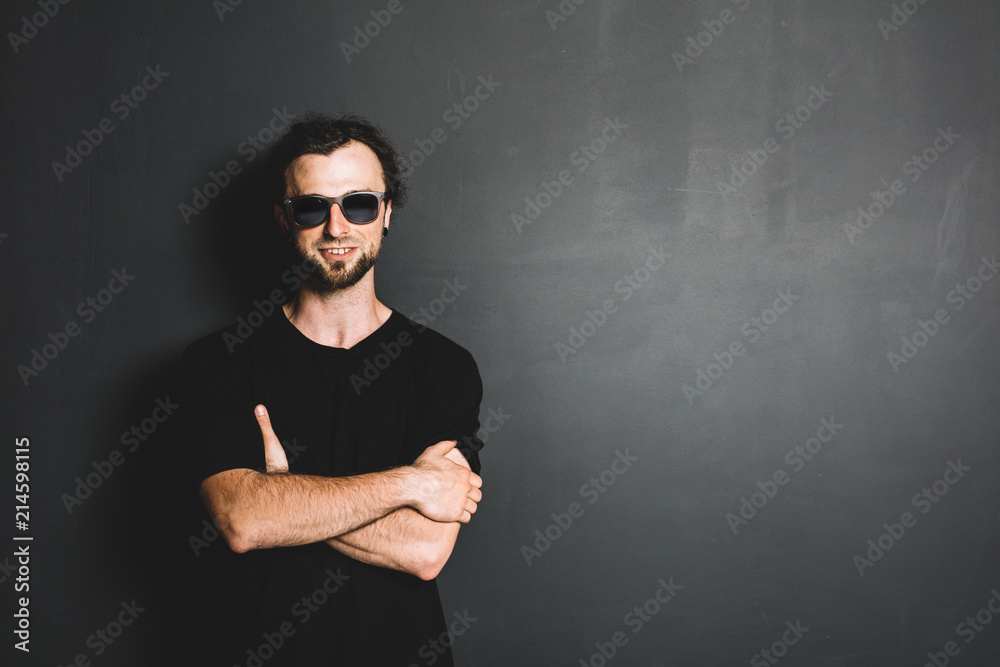 Portrait of smiling casual man standing on grunge wall. Portrait of smiling casual man standing on grunge wall.