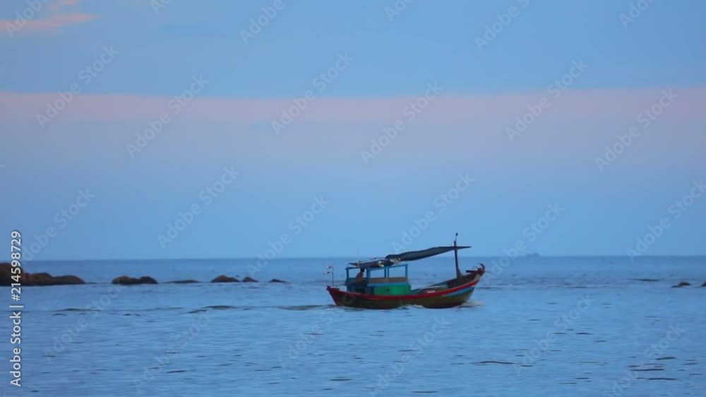 Fisherman in a small wooden fishing boat navigating across the south china sea, under tropical sunset skies high definition stock footage clip. Fisherman in a small wooden fishing boat navigating across the south china sea, under tropical sunset skies high definition stock footage clip.