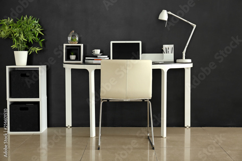 Stylish workplace with lapt...
