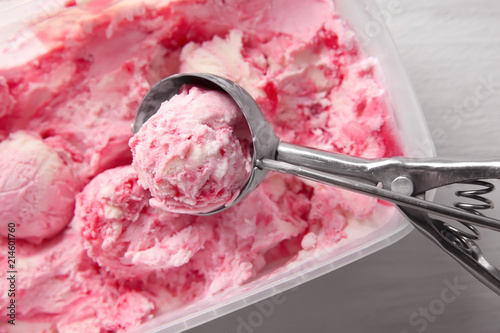 Tasty strawberry ice-cream with scoop, closeup