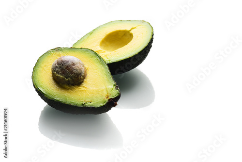 Close view of avocado halves isolated on white background
