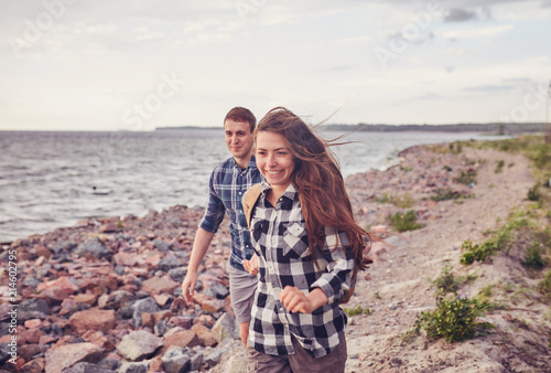 happy couple running near the lake